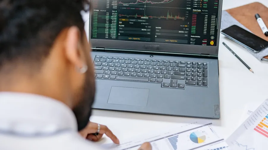 Business professional reviewing IT budget on a laptop