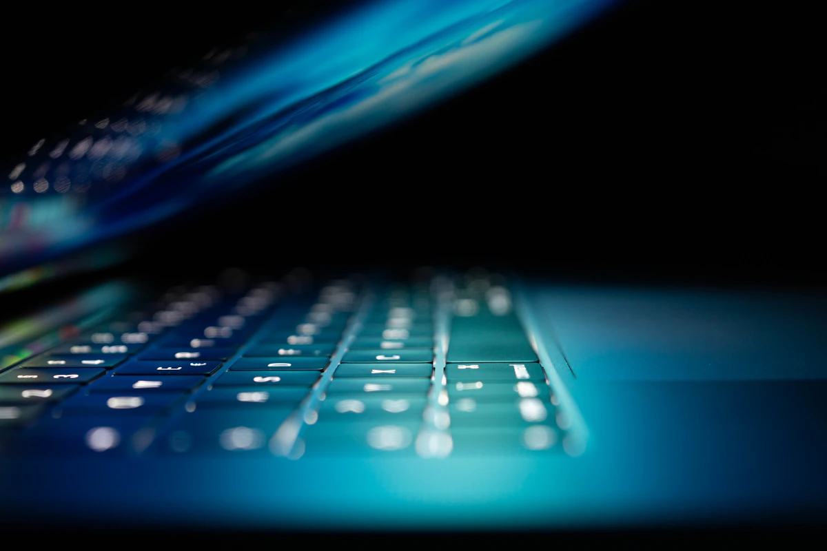 Blue glowing laptop screen, cybersecurity framework comparison